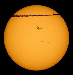 Giant sunspot 720 and a passing airplane